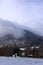 Panoramic view of the snowy Puy-de-Dome, hanging the clouds