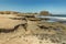 Panoramic view of the south coast of El Medano. Old military bunker in the middle and sand beach with people bathing in the