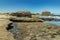 Panoramic view of the south coast of El Medano. Old military bunker in the middle and sand beach with people bathing in the
