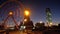 Panoramic view Statue of Ali and Nino on a background Ferris wheel at night on the embankment of Batumi, Georgia