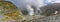 Panoramic view of steam vents and rocky hills on White Island, New Zealand`s most active cone volcano