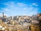 Panoramic view of stones of Matera under blue sky