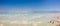 Panoramic view of the stunning blues and stark white salt piles dotting the Dead Sea