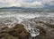 Panoramic view of the Stunning storm clouds, waves and the rocky beach in the Aegean sea on a summer day on the island of Evia, Gr