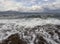 Panoramic view of the Stunning storm clouds, waves and the rocky beach in the Aegean sea on a summer day on the island of Evia, Gr