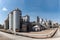 Panoramic view of a sugar factory\\\'s exterior, with storage silos, smokestacks, and a network of pipes and conveyors