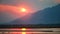 Panoramic view of sunset on the african Zambezi river. The dramatic, red sky reflects on the surface of the border river. View