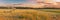 Panoramic View Of Sunset Sky Above Irrigation Pivot. Irrigation Machine At Agricultural Field With Young Sprouts, Green