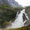 Panoramic view to kleivafossen waterfall at briksdalselva river, Briksdalsbreen glacier, Norway