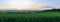 Panoramic view to nice wave green field with trees and city Ceske Budejovice at sunset. Czech republic