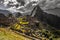 Panoramic view to old Inca ruins and Wayna Picchu with grey clou