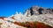 Panoramic view of Torres del Paine National Park, its forests and summits at golden Autumn and group of hikers and flying condors