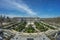 Panoramic view of tourists gathering around Royal Palace (Palacio Real), Plaza de Oriente, Lepanto Gardens (Jardines de Lepanto) a