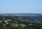 A panoramic view of the town of west yorkshire from above with streets and houses surrounded by trees and fields