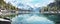 panoramic view of a tranquil lake surrounded by towering mountains, with the reflection of the snow-capped peaks panorama