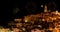 Panoramic view of typical stones Sassi di Matera and church of Matera at night, with golden abstract blinking sparkle
