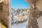 Panoramic view of typical stones Sassi di Matera and church of Matera under arcade