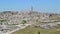 Panoramic view of typical stones Sassi di Matera and church of Matera under blue sky. Basilicata, Italy, zoom out camera