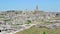 Panoramic view of typical stones Sassi di Matera and church of Matera under blue sky. Basilicata, Italy, zoom out camera