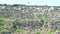 Panoramic view of typical stones Sassi di Matera and church of Matera under blue sky. Basilicata, Italy, zoom out camera