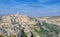 Panoramic view of typical stones (Sassi di Matera) and church near gravina of Matera UNESCO European Capital of Culture 2019 under