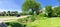 Panoramic view typical Texas residential neighborhood with single story house, sidewalk and green lawn