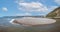 Panoramic view of U shaped entrance to Axmouth harbour with large spit of shingle