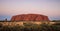 Panoramic view on Uluru, or Ayers Rock at sundown a massive sandstone monolith in the heart of the Northern Territory, Australia