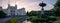 Panoramic view of the university building and the park and fountain in front of it in Lund Sweden during summer sunset