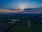 Panoramic view of the valley with green fresh fields and meadow at sunset.