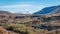 Panoramic view of a valley with a train and railway with snow capped mountains and Firat river near Erzincan, Turkey