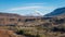 Panoramic view of a valley with a train and railway with snow capped mountains and Firat river near Erzincan, Turkey