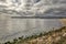 Panoramic view of the Varna bay , beach , rocks,birds, black sea and cloudy sky.