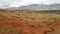 Panoramic view of the very bright red-orange mountains Kyzyl Chin in the Altai Republic in Russia. Journey to Altai Mars.