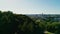 Panoramic view of the Vilnius city center and skyline of downtown from behind the trees of the park on a sunny evening