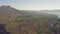 Panoramic view of volcano mountain with a rural village and burnt slope.