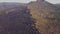 Panoramic view of volcano mountain with a rural village and burnt slope.