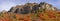 Panoramic view of Wasatch mountain peaks surrounded with fall foliage on the slopes in Utah