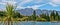 Panoramic view of water, mountains, trees, and boats