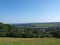 Panoramic view west yorkshire countryside with the village of warley surrounded by woodland and farmland with pennine hills in