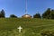 Panoramic view of a white marble cross in front of the pantheon and house at Arlington National Cemetery.