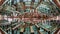 A panoramic view of a white whale skeleton hanging from the ceiling of the Biblioteca Vasconcelos in Mexico City