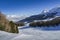 Panoramic view of wide and groomed ski piste in resort of Pila in Valle d`Aosta, Italy during winter