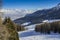 Panoramic view of wide and groomed ski piste in resort of Pila in Valle d`Aosta, Italy during winter