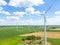 Panoramic view of wind farm or wind park, with high wind turbines for generation electricity with copy space. Green energy concept