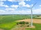 Panoramic view of wind farm or wind park, with high wind turbines for generation electricity with copy space. Green energy concept