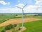 Panoramic view of wind farm or wind park, with high wind turbines for generation electricity with copy space. Green energy concept