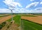 Panoramic view of wind farm or wind park, with high wind turbines for generation electricity with copy space. Green energy concept