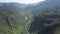Panoramic view winding river between green jungle hills