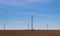 A panoramic view of the windmill installed in a field installation wind turbine with blue sky background